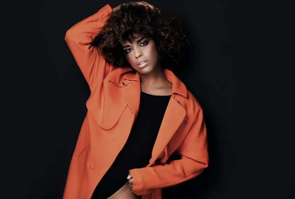 Fashionable woman in orange coat. — Stock Photo, Image