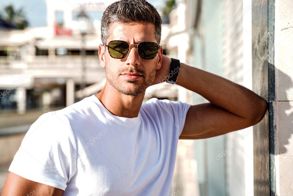 Handsome young man portrait. Men wearing fashionable sunglasses Sunny day