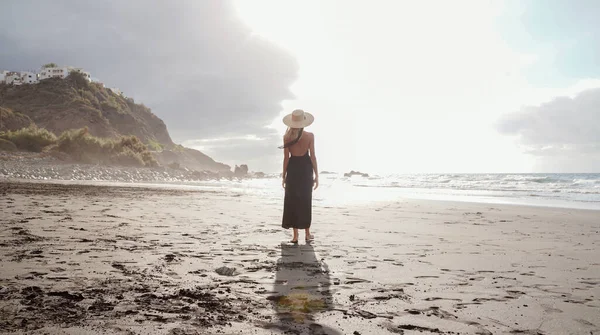 Smuk Romantisk Kvinde Går Den Tomme Strand Solnedgang Iført Sommerhat - Stock-foto