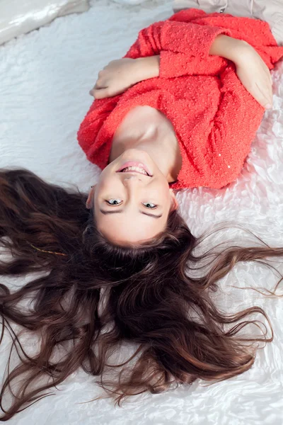 Teenage girl in bed smiling Stock Photo