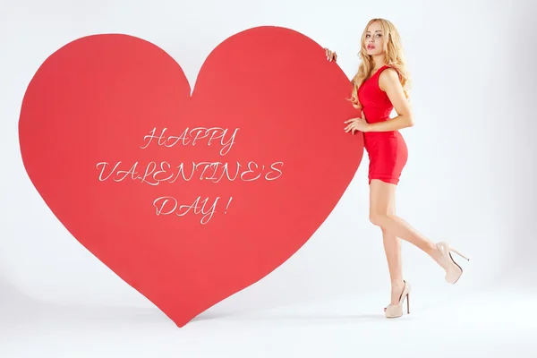 Sexy blonde woman with big heart. — Stock Photo, Image