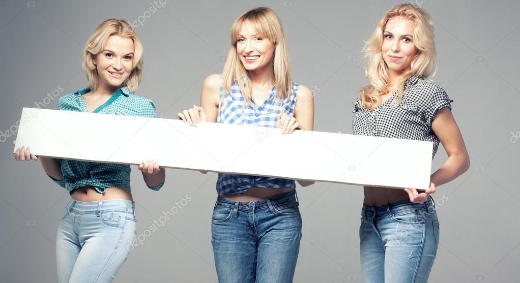 Three girls with empty board.