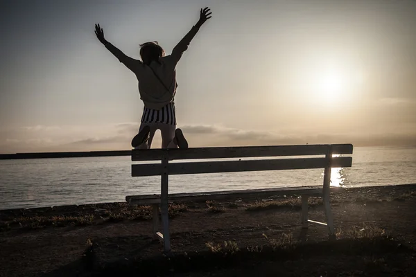 Girl jumping over sunrise. — Stock Photo, Image