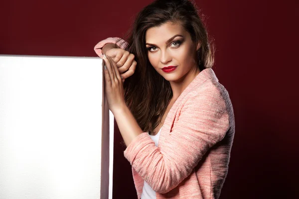 Beautiful girl showing empty board. — Stock Photo, Image