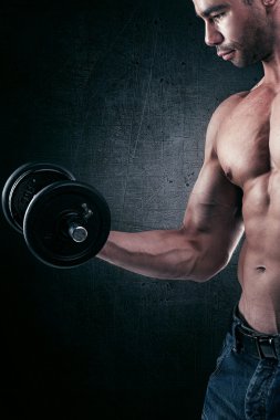 Muscular handsome man working out.