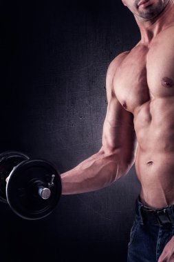 Muscular handsome man working out.