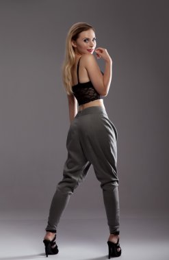 Fashionable blonde lady posing in studio.