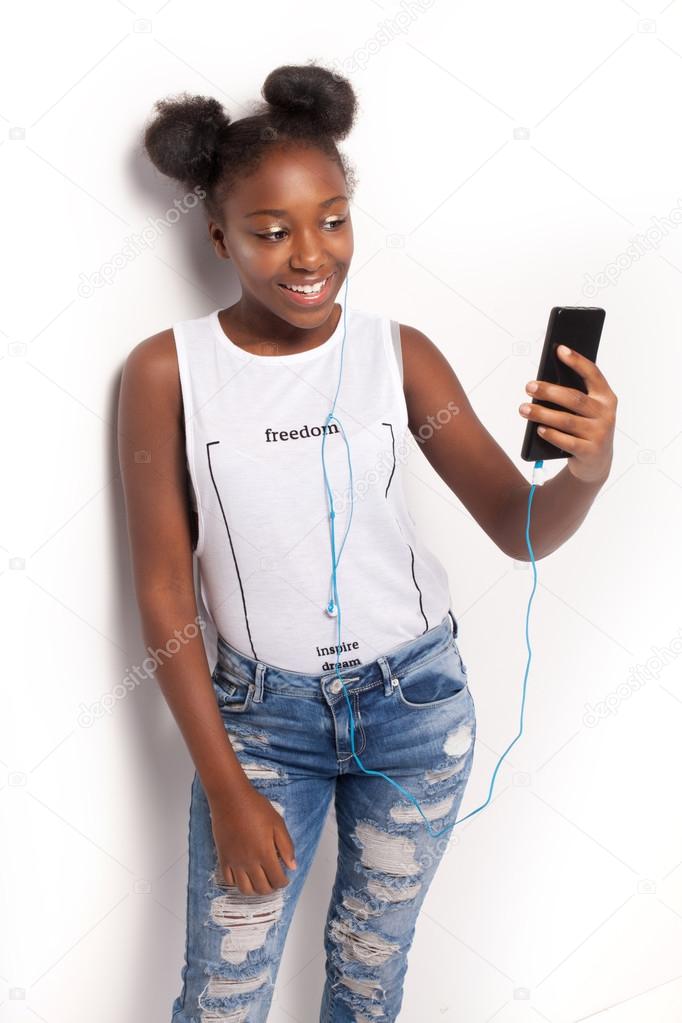 Smiling young girl listening to music.