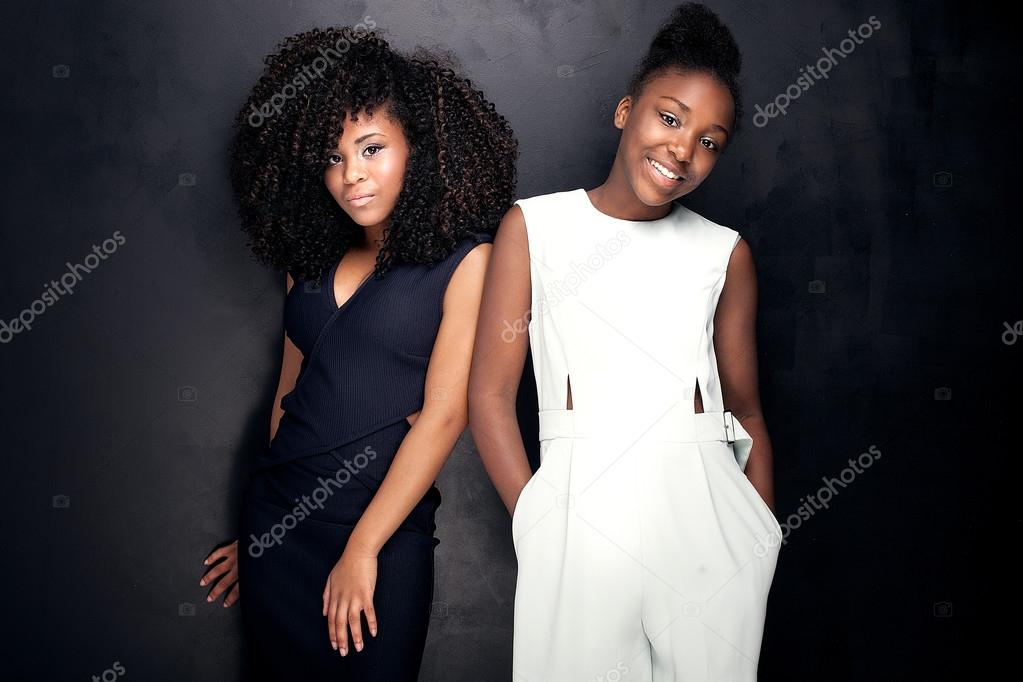 Two beautiful young sisters posing.