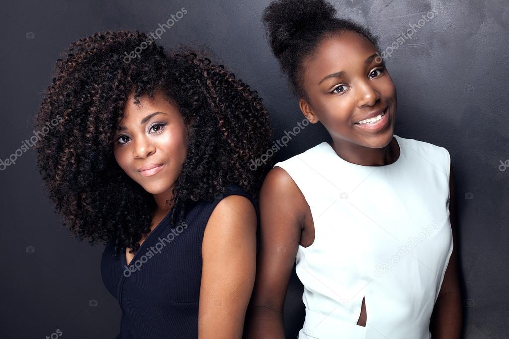 Two beautiful young sisters posing.