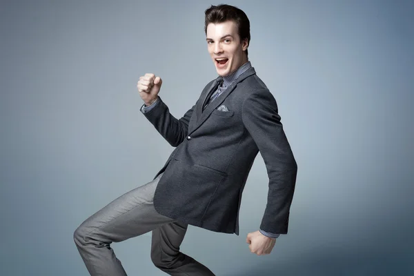 Running businessman. Studio shot.