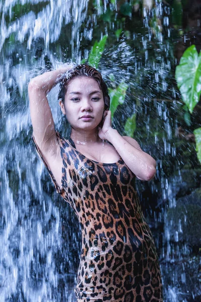 asia sexy girl under relaxing hot waterfall