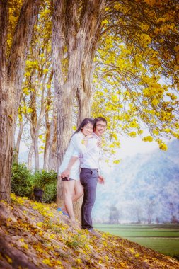 Asya mutlu çift ayakta ağacının altında