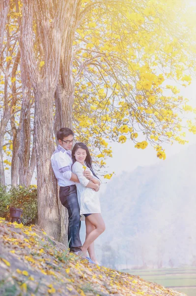 asia happy couple standing under tree