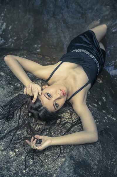 Asya güzel genç seksi kız kayanın üzerinde uzanmış — Stok fotoğraf