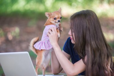Onu köpek ve dizüstü olan mutlu kadın 