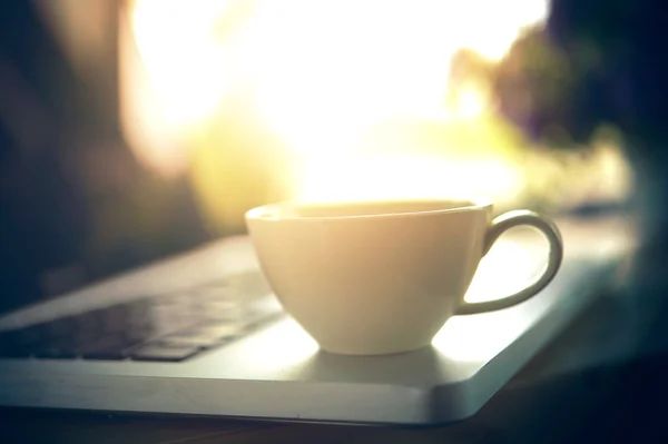 Białe filiżanka kawy i laptop dla biznesu — Zdjęcie stockowe
