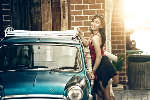 Mujer asiática de pie cerca de la puerta del coche vintage — Foto de Stock