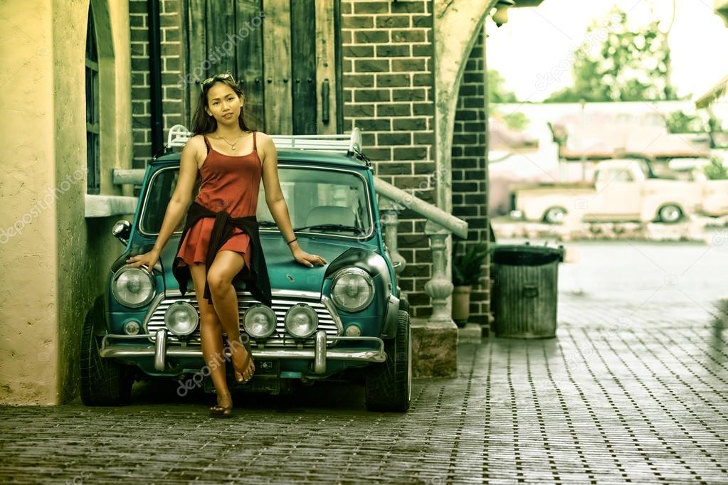 asia beautiful lady standing near retro car
