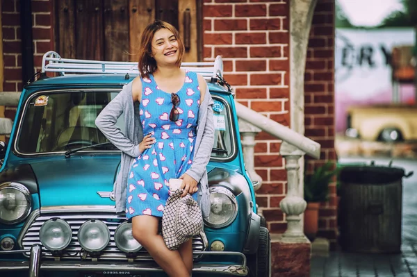 Asya güzel Bayan Retro arabanın yakınında ayakta