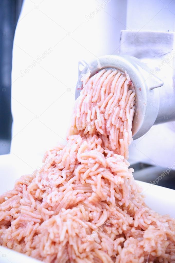 Mincer machine and fresh chopped meat 
