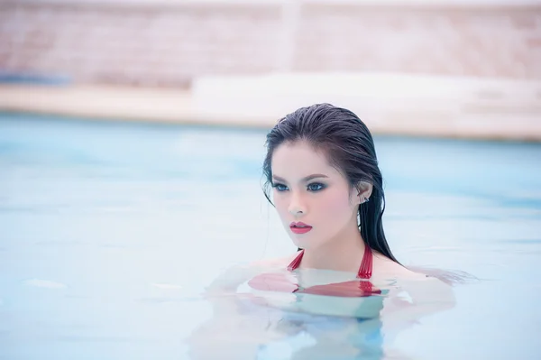 Asia sexy joven mujer de pie en el agua en la piscina — Foto de Stock