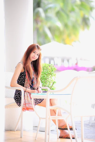 Asia young woman sitting on modern white chair — Stock Photo, Image