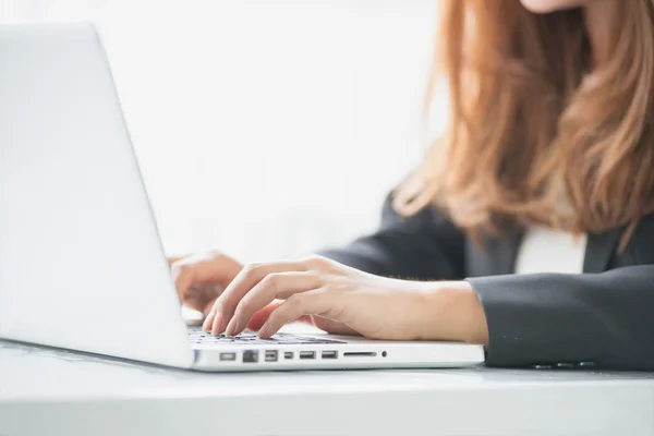 asia woman working with notebook in the office