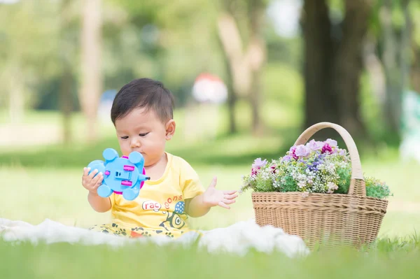 Asia Baby boy on green grass in the park — Stock Photo, Image