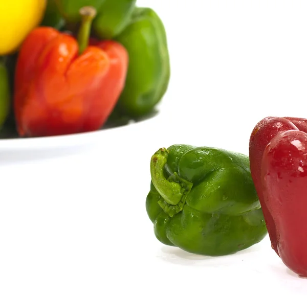 Red green and orange sweet bell peppers isolated on white — Stock Photo, Image