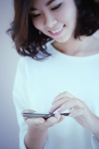 asia happy young woman with her smart phone