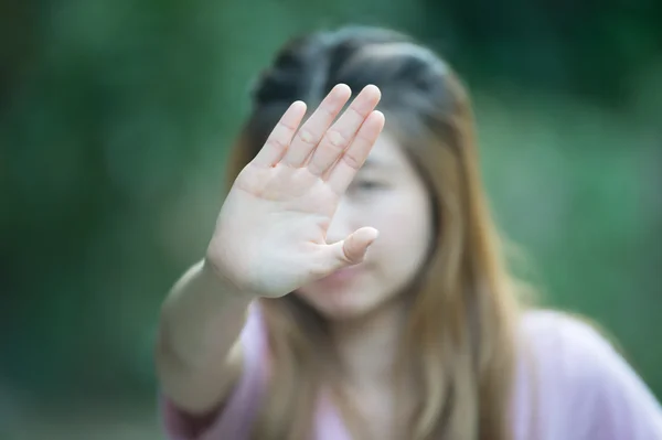 Asian women showing stop hand gesture,  focus hand