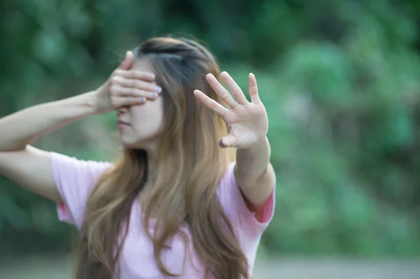 asia woman covers her face with hand shows stop