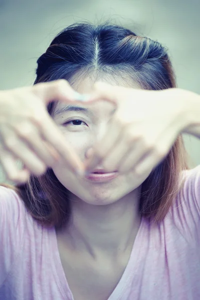 Asia happy young woman making heart sign with hands — Stock Photo, Image
