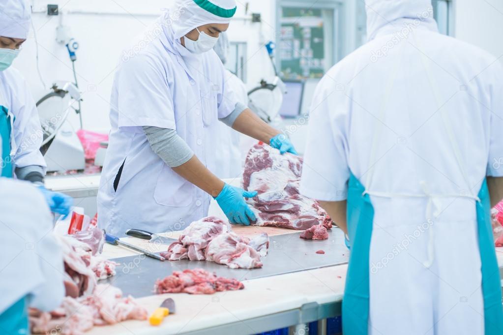 cutting meat slaughterhouse workers in the factory