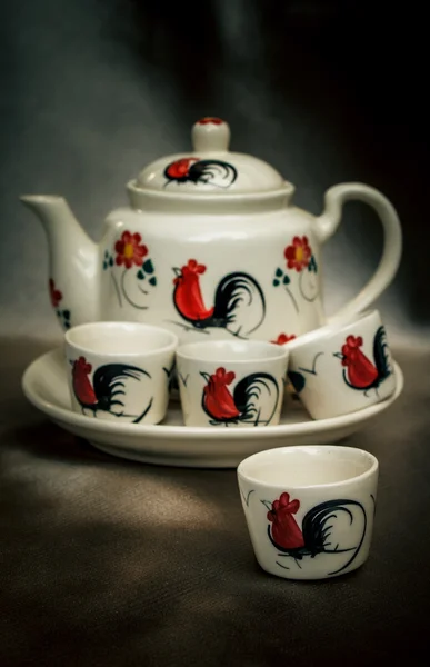 Traditional tea set, cups with teapot on fabric. — Stock Photo, Image