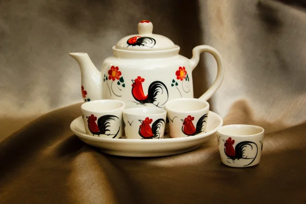 Traditional tea set, cups with teapot on fabric. — Stock Photo, Image