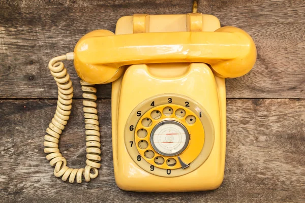 Old yellow phone with dust and scratches, still life. — Stock Photo, Image