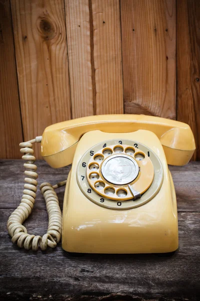 Old yellow phone with dust and scratches, still life. — Stock Photo, Image