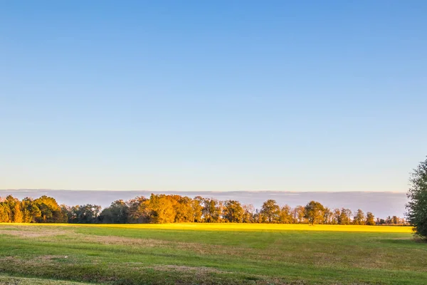 View of open country land and clouds on the horizon in the south