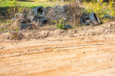 Yol kenarında terk edilmiş eski bir lastik yığını.