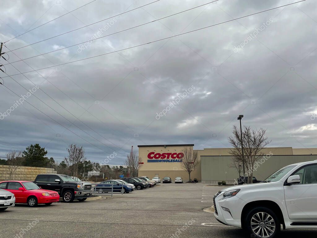 Augusta, Ga USA - 01 21 21: Costco Wholesale retail store building parking lot view parked cars cloudy sky
