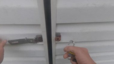 Burke County, Ga USA - 05 10 21: Person opening the door to an outdoor shed