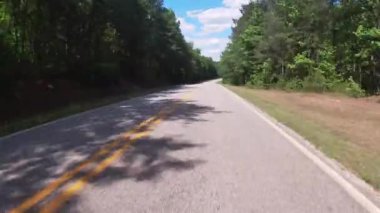 FPV Driving on a country rural road with lush green forest and blue sky with clouds - Georgia