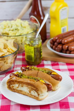 Grilled Hot Dogs on a Picnic Table clipart