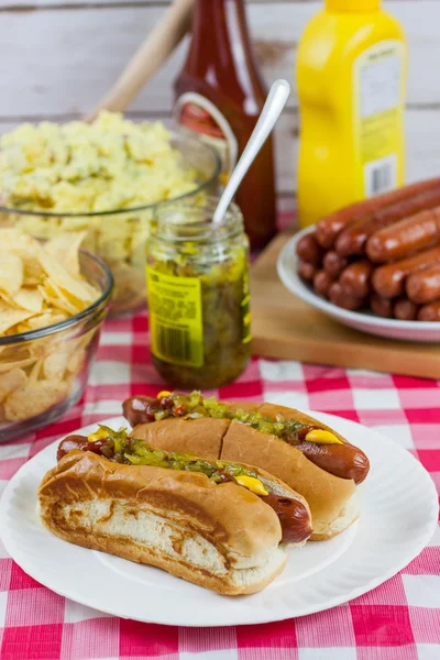 Grilled Hot Dogs on a Picnic Table