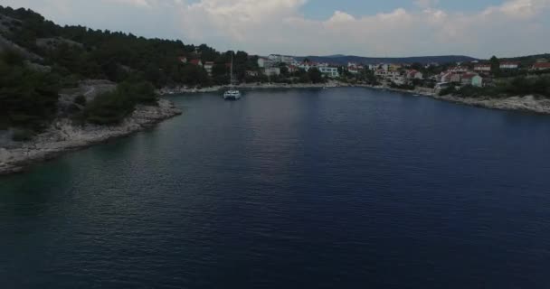 Aerial drone scene of bay with anchored catamaran in dalmatian coast, Croatia. — Stock Video