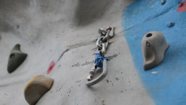 Detail of carabiner in climbing wall. — Stock Video