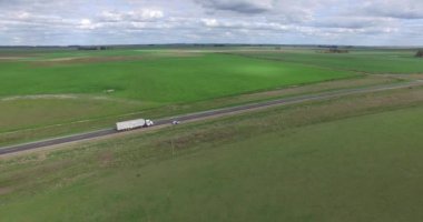 Yalnız bir yol kırsal, yakalama bir kamyonun yolun hızlı gidiş hava dron sahne. Tarım peyzaj.