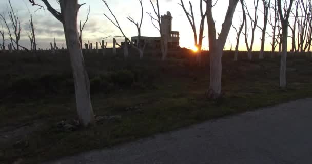 Aerial Drone scene of an abandoned Slaughterhouse at sunset, surrounded by dead trees in Epecuen at buenos aires argentina. Horrifying and scary exterior panorama. — Stock Video